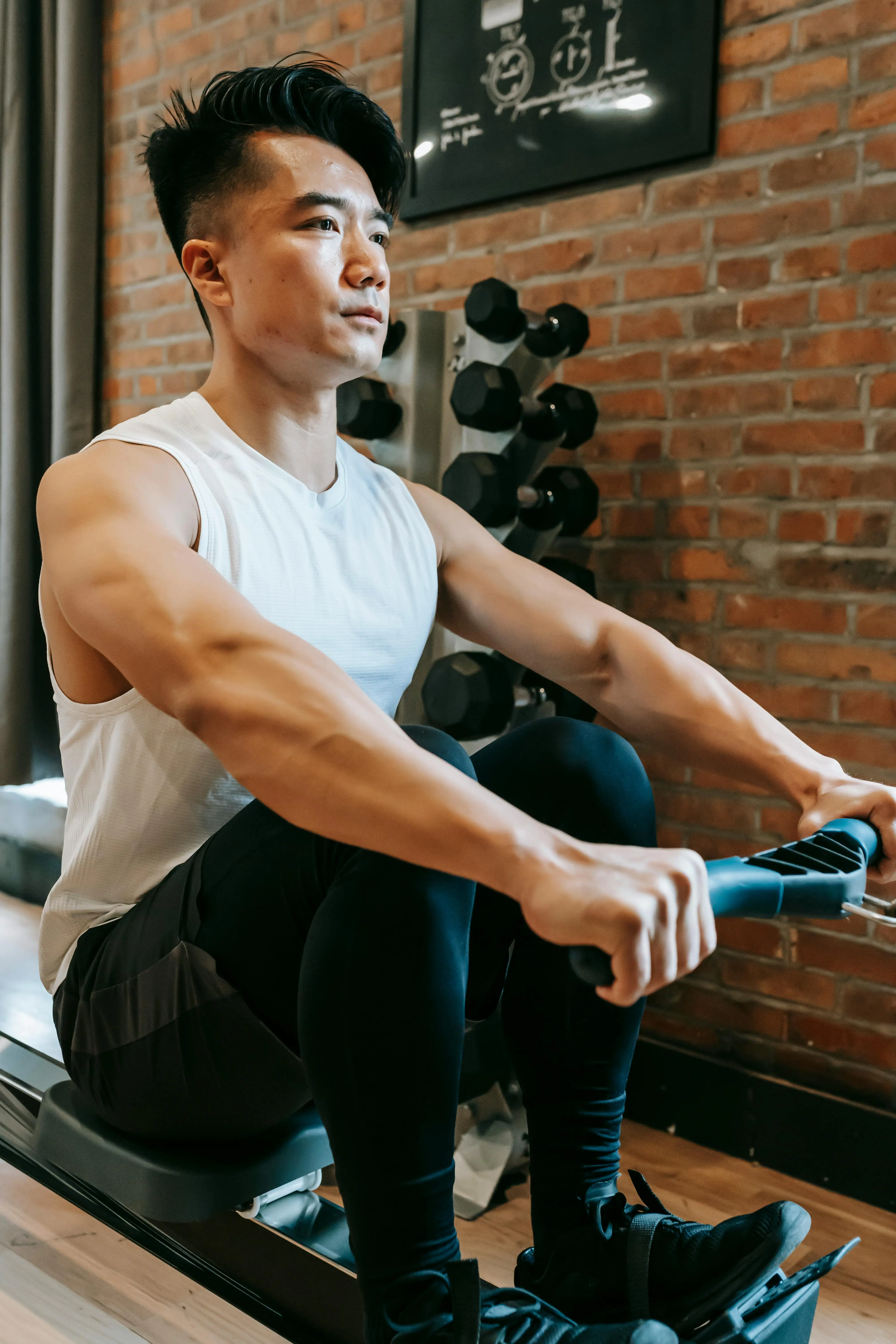 A man sitting on a rowing machine