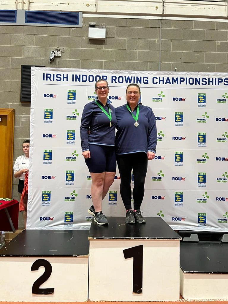 Two members on the winners podium with medals